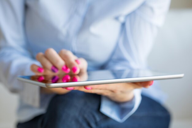 Woman using tablet computer closeup photo