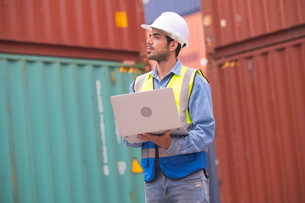 Worker using computer in containers export background Engineer using computer in containers import background