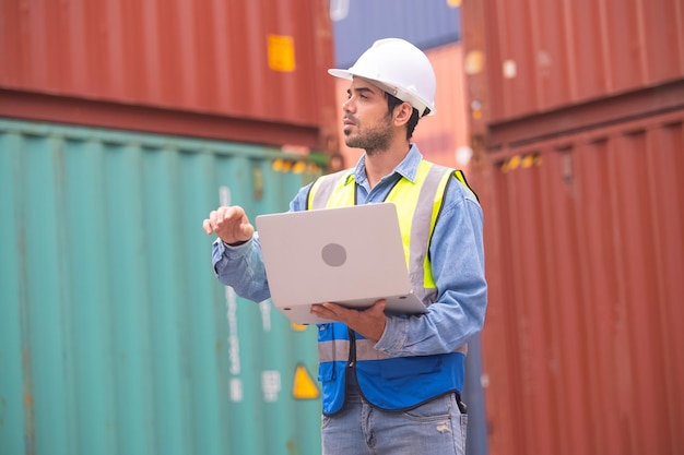 Worker using computer in containers export background Engineer using computer in containers import background