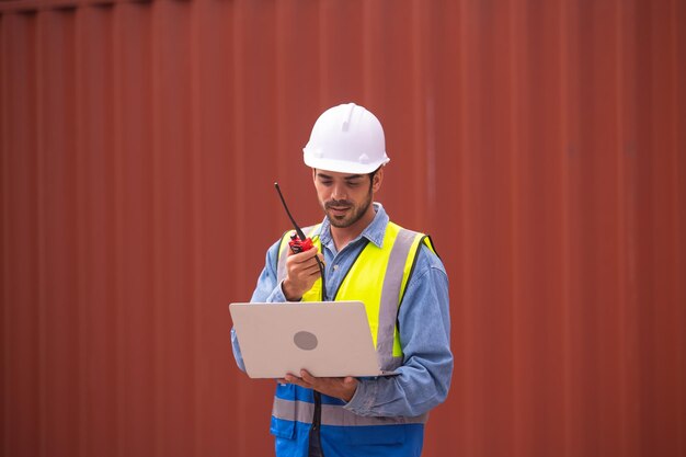 Worker using computer in containers export background Engineer using computer in containers import background