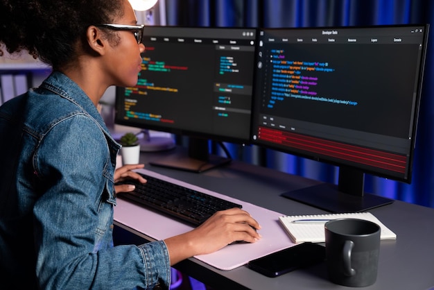 Young African American IT developer concentrating on monitor screen laptop with codding program in data of application and website Concept of creating innovative html updated version Tastemaker