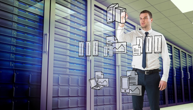 young businessman writing with marker against server room
