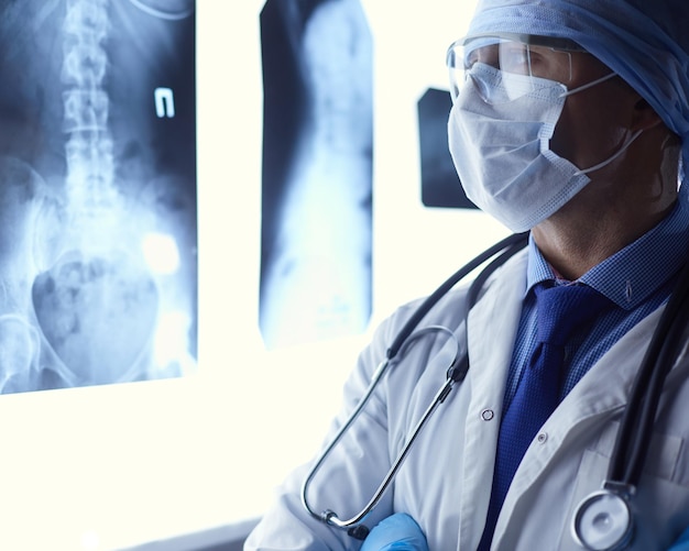 Young doctor looking XRay image on isolated white background