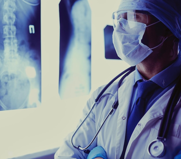 Young doctor looking XRay image on isolated white background