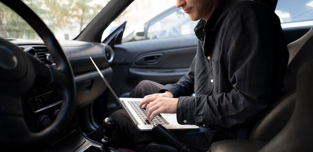 a car mechanic doing auto diagnostic using computer, searching for check engine