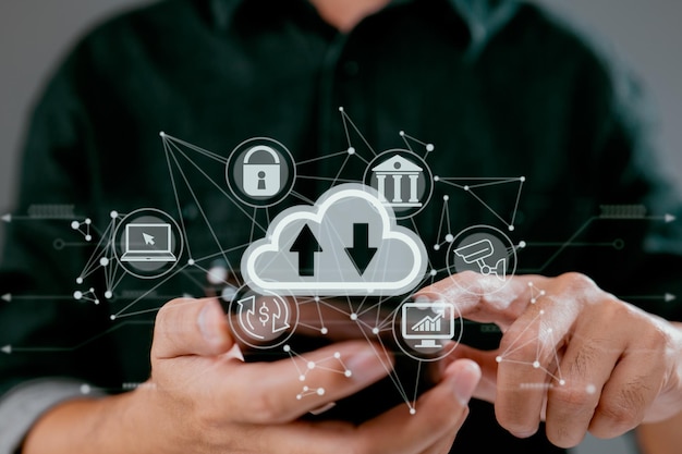 A guy uses a smartphone while holding a cloud computing diagram Data storage networking and internet service principles are all part of cloud technology