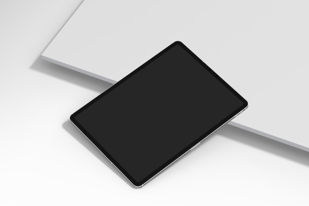 A laptop with a black tablet on it and a white laptop on the right side.