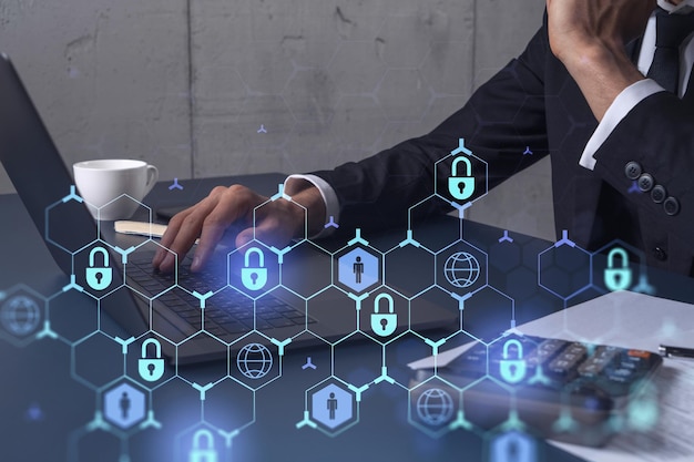 A programmer is typing a code on computer to protect a cyber security from hacker attacks and save clients confidential data Padlock Hologram icons over the typing hands Formal wear