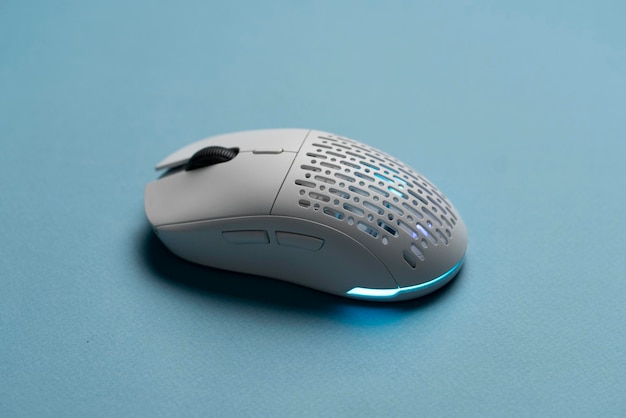 A white new wireless computer mouse flat lay with led lights