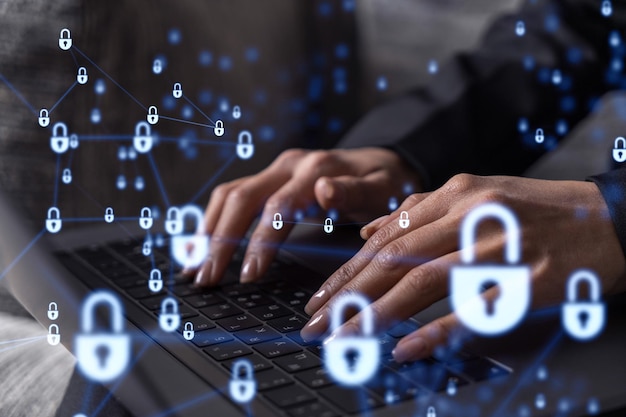 A woman programmer is typing a code on computer to protect a cyber security from hacker attacks and save clients confidential data Padlock Hologram icons over the typing hands Formal wear