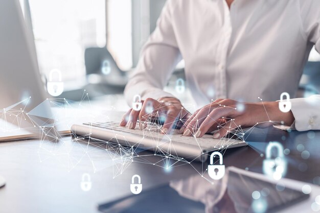 a woman programmer is typing a code on computer to protect a cyber security from hacker attacks and save clients confidential data padlock hologram icons over the typing hands formal wear