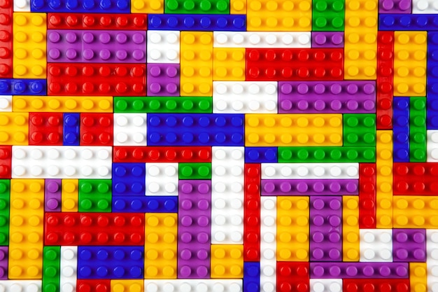abstract background texture of colored constructor blocks background of colorful plastic part of constructor pile of colored toy bricks