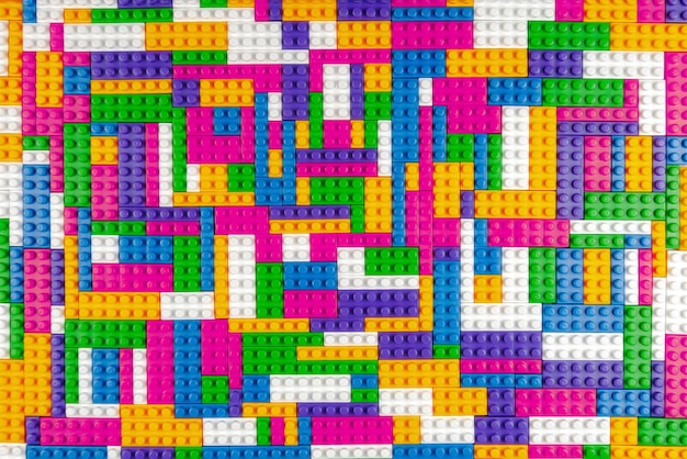 abstract background texture of colored constructor blocks background of colorful plastic part of constructor pile of colored toy bricks