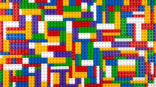 abstract background texture of colored constructor blocks background of colorful plastic part of constructor pile of colored toy bricks