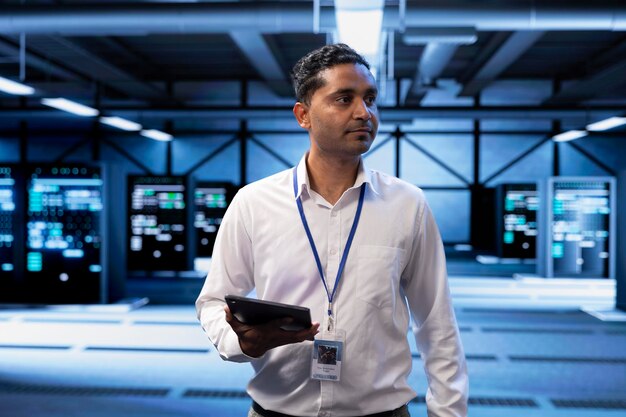 Admin in server hub checking recovery plan on tablet monitoring data center