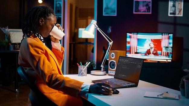 African american it specialist working with coding language and infographics