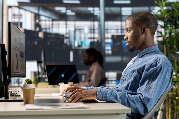 African american male professional works at desk in a corporation
