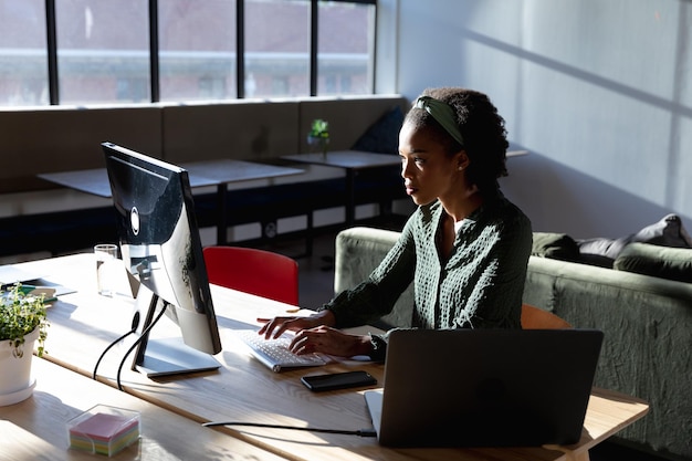 African american young businesswoman using computer at desk in office