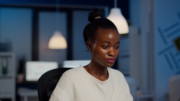 african bookkeeper working overtime calculating profit