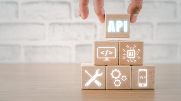 API Application Programming Interface Wooden block with VR screen API icon on office desk Software development tool modern technology internet and networking concept