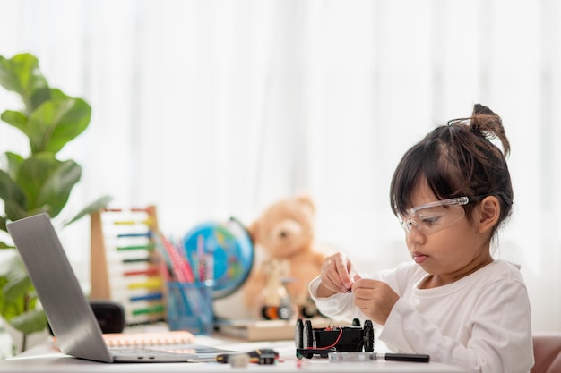 asia students learn at home in coding robot cars and electronic board cables in stem steam mathematics engineering science technology computer code in robotics for kids concept