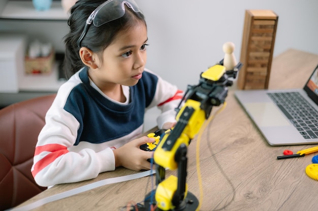 Asian girls were learning robot programming and getting lessons control on robot arms Laboratory Mathematics engineering science technology computer code coding STEM education