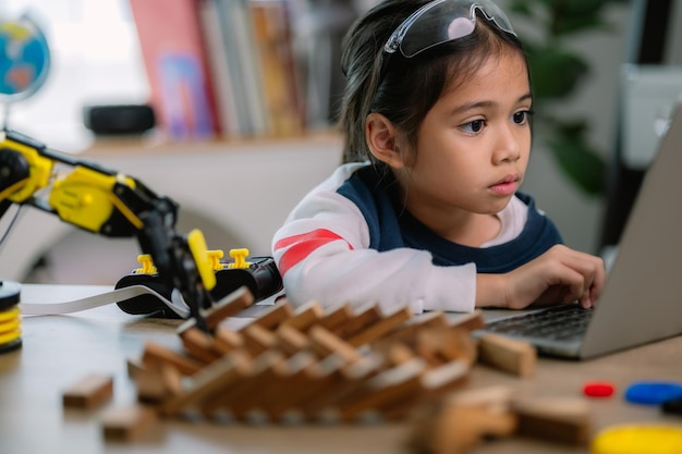 Asian girls were learning robot programming and getting lessons control on robot arms Laboratory Mathematics engineering science technology computer code coding STEM education