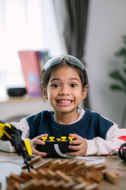 Asian girls were learning robot programming and getting lessons control on robot arms Laboratory Mathematics engineering science technology computer code coding STEM education