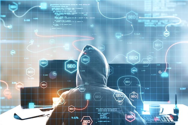 Back view of hacker at desktop using abstract interface with glowing SEO hologram and icons on blurry background Search engine optimization hacking and coding concept Double exposure