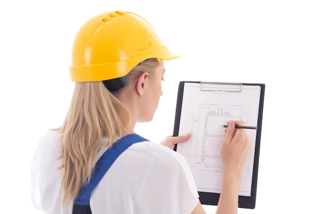 Back view of woman in blue builder uniform holding building scheme isolated on white