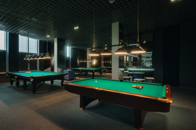 Billiard table with green surface and balls in the billiard club