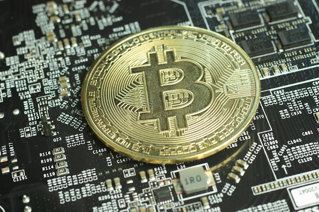 Bitcoin cryptocurrency on motherboard electronic circuit close up Mining BTC concept