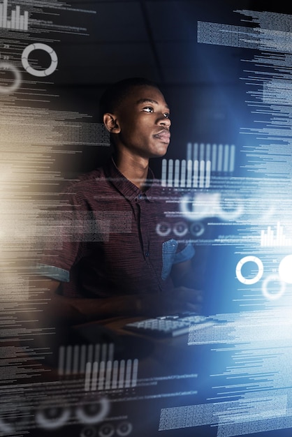 Black man programmer or night with overlay on computer for data analysis or future development at office Young African male person or coder working late on futuristic technology hud or dashboard
