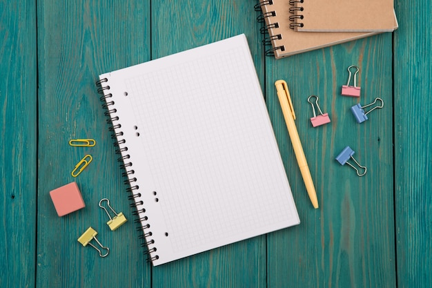 Blank sheet of paper and colorful office accessories