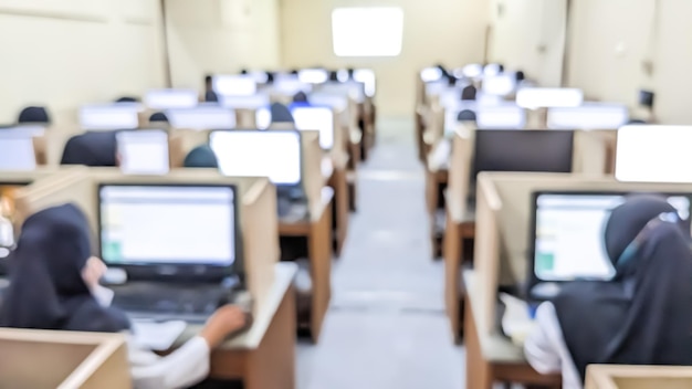 Blurred image of amount of students working on a computerbased competency test in the Computer Class