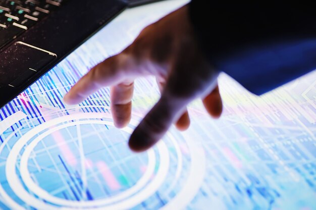 business concept. information technology and data processing. hands over the screen with graphic data. a modern software product in business.