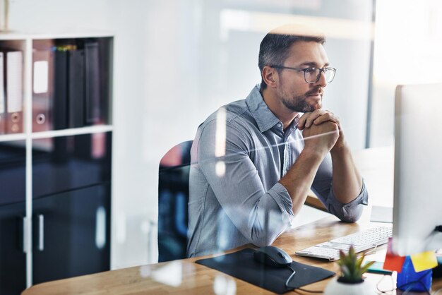 Business man thinking and planning on computer for information technology or programming solution Programmer or online developer reading on desktop for web problem solving decision or reflection