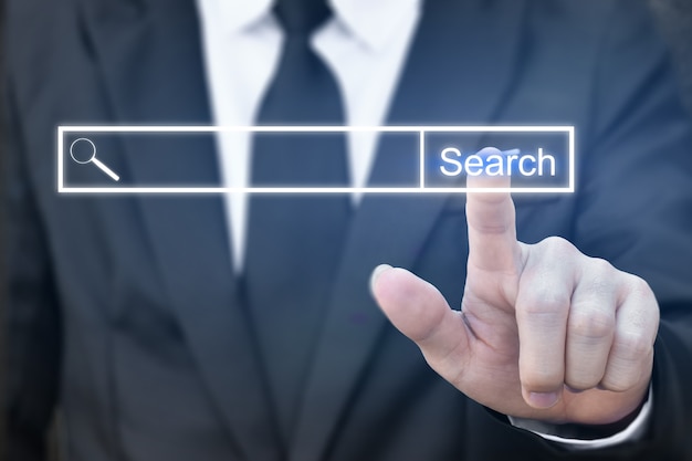 Businessman clicking internet search page on virtual screen.