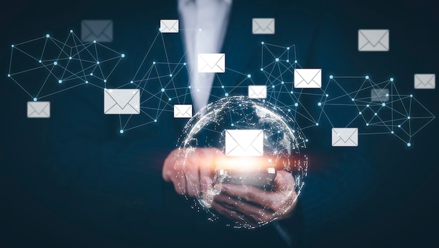 businessman hand holding email icon letter on a touch screen interface virtual postal envelope concept of spam email internet and networking contact us newsletter email and protect your personal