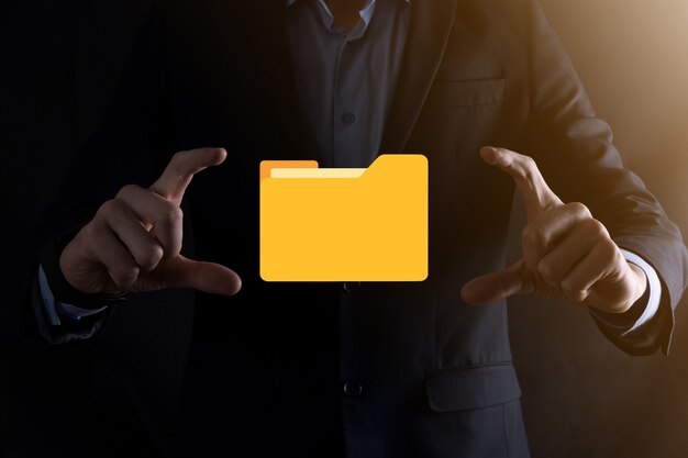 Businessman hold folder icon.Document Management System or DMS setup by IT consultant with modern computer are searching managing information and corporate files.Business processing,
