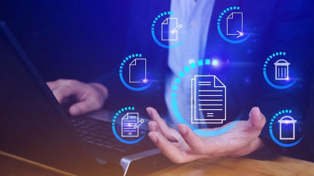 Businessman holding multimedia type of modern buttons with virtual background Document Management System DMS searching and managing corporate files information