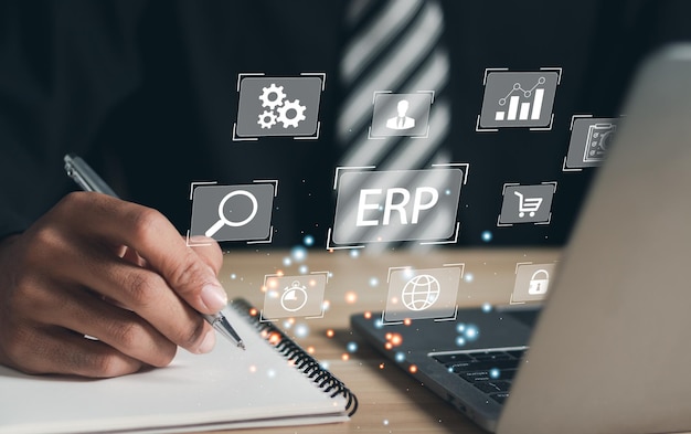 Businessman use laptop to document management for ERP Modern technology concept on virtual screen Enterprise Resource Planning or ERP concept