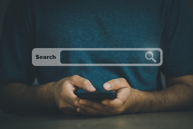 Businessman use mobile phone searching browsing internet data information with blank search bar Search engine optimization SEO networking concept businessman working with smartphone on desk