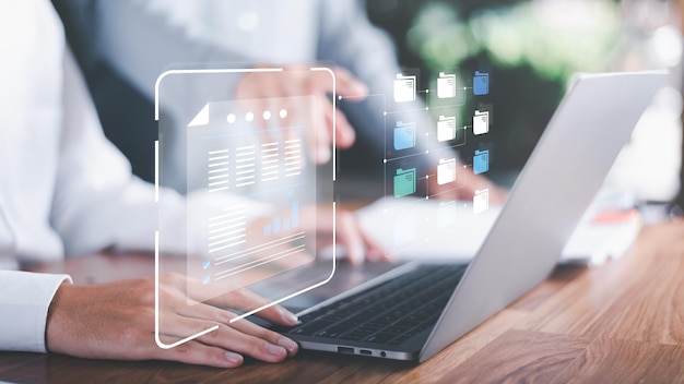 Businessman using laptop to access documents onlineDocument Management SystemManag
