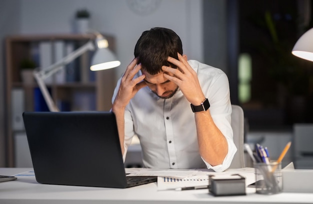 businessman with papers working at night office