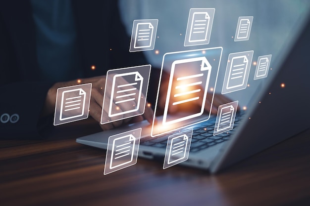 Businessman working on laptop with virtual screen Online documentation database and document management system concept Process automation to efficiently manage files
