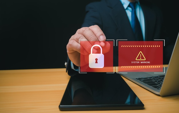 Businessman working on tablet and computer online showing protection icons cyber espionage