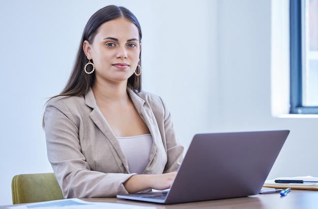 Businesswoman portrait and office with laptop working and confidence for intern goals Creative writer professional news editor or expert reporter for content creation publishing or press startup