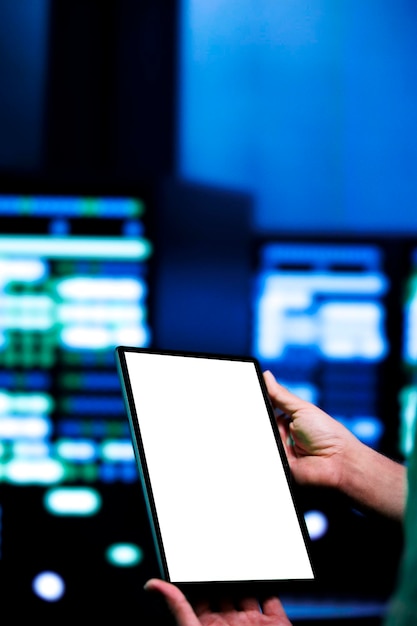Certified expert conducting yearly auditing of data center servers using mock up tablet to optimize its lifespan, prevent system failures and ensure uninterrupted computing power