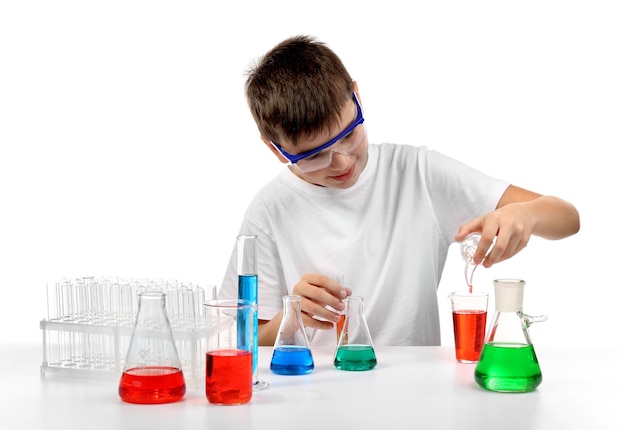 Clever little boy doing a chemical experiments isolated on white
